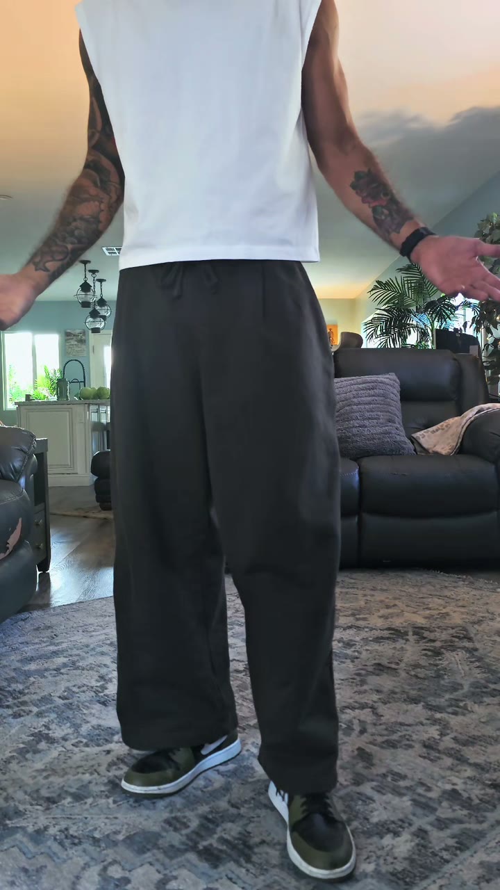 Xavier standing in pleated 7th Earth sweats